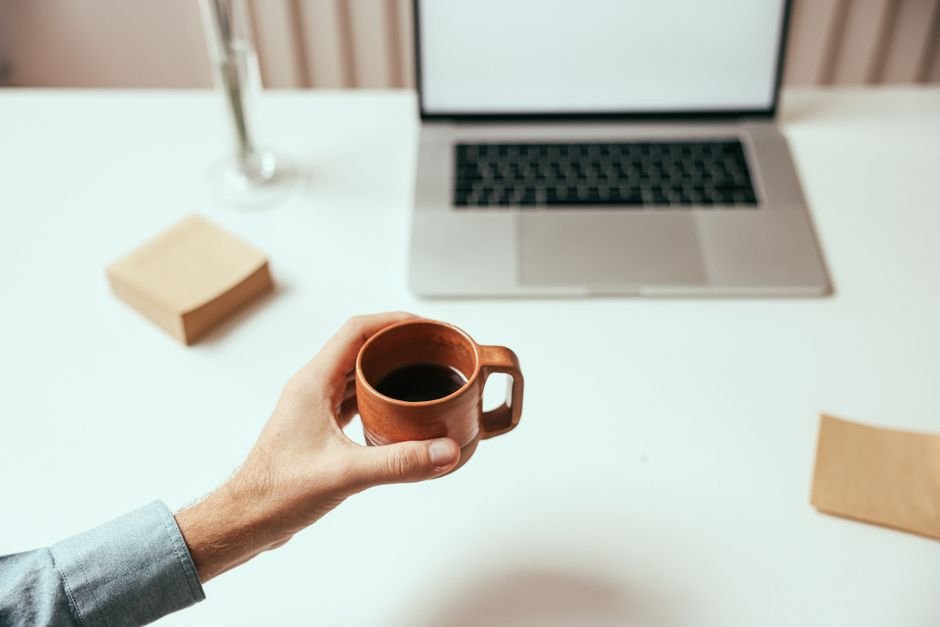 Home workspace with a laptop — most ways to make money with AI start with a skill, not capital