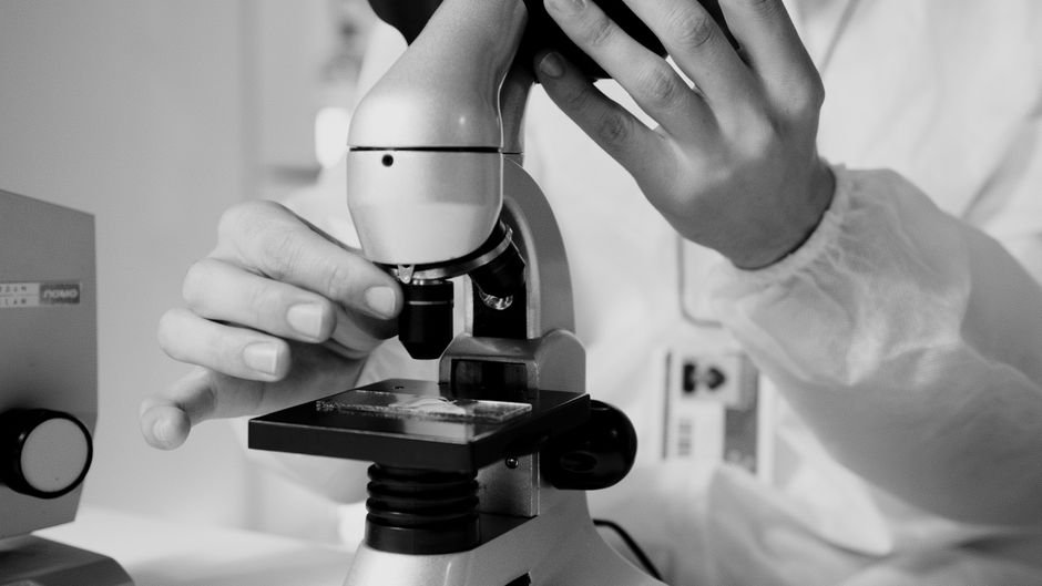 Scientist at a microscope, representing the STEM expert network Sepal AI recruited from