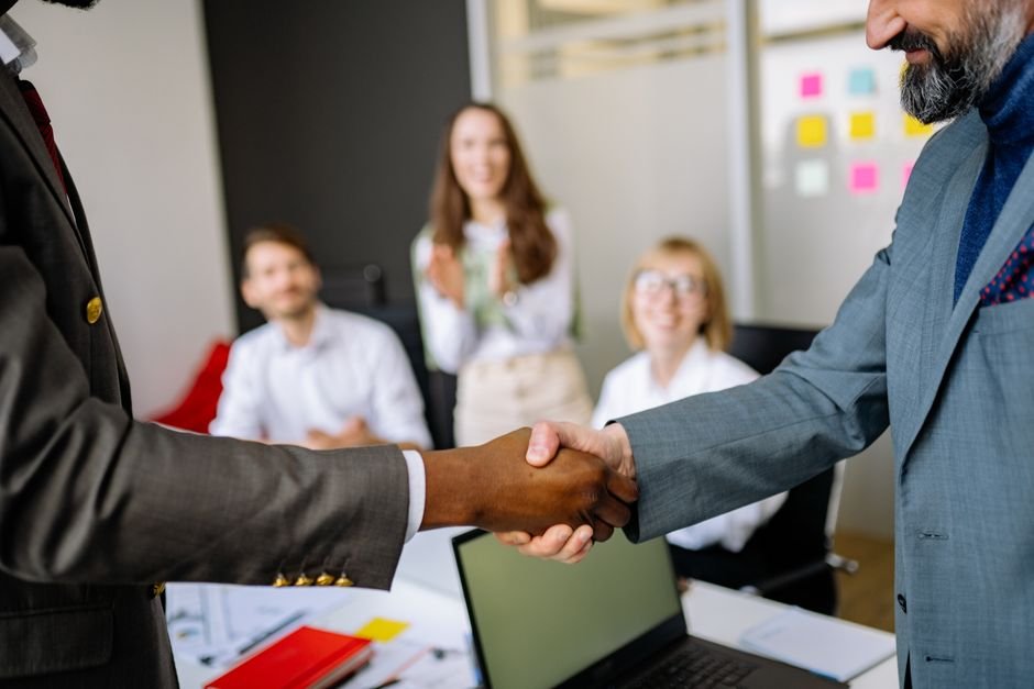 Two people shaking hands, representing the Mercor acquisition of Sepal AI